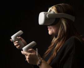 A student with a virtual reality headset and controllers.