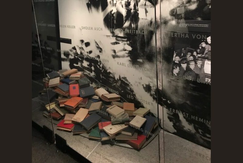 A museum display of a pile of books