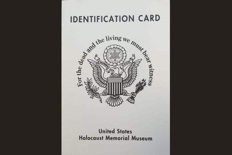 A card with the United States eagle seal with the words “Identification Card” at the top and the phrase “For the dead and the living we must bear witness” above the seal. The bottom reads “United States Holocaust Memorial Museum.”