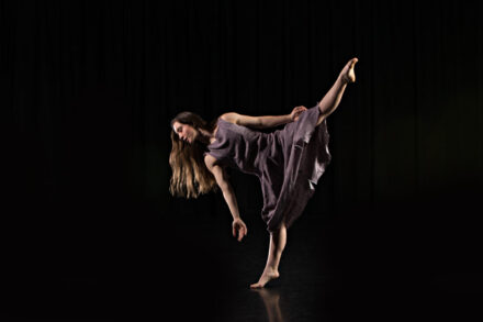 Dancer in purple dress in tilt position
