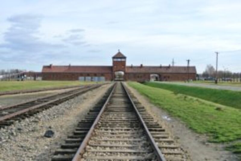 Far image of main entrance at Auschwitz II Birkenau with train tracks