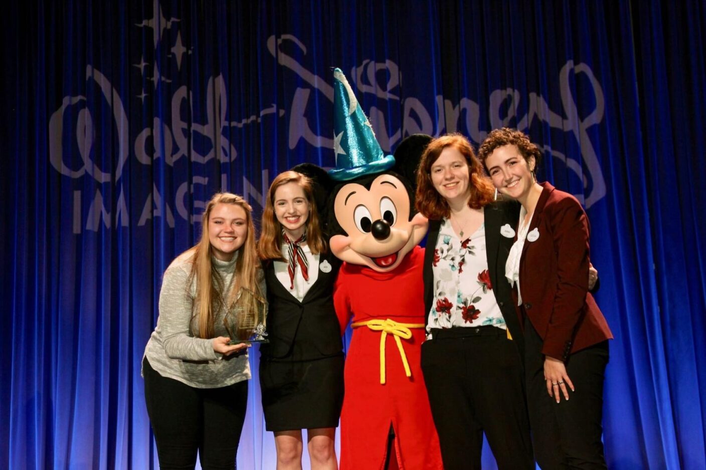 Kennedy Behling, Abby Zuber, Abby Henning and Cecilia Gonzalez posing with Mickey Mouse