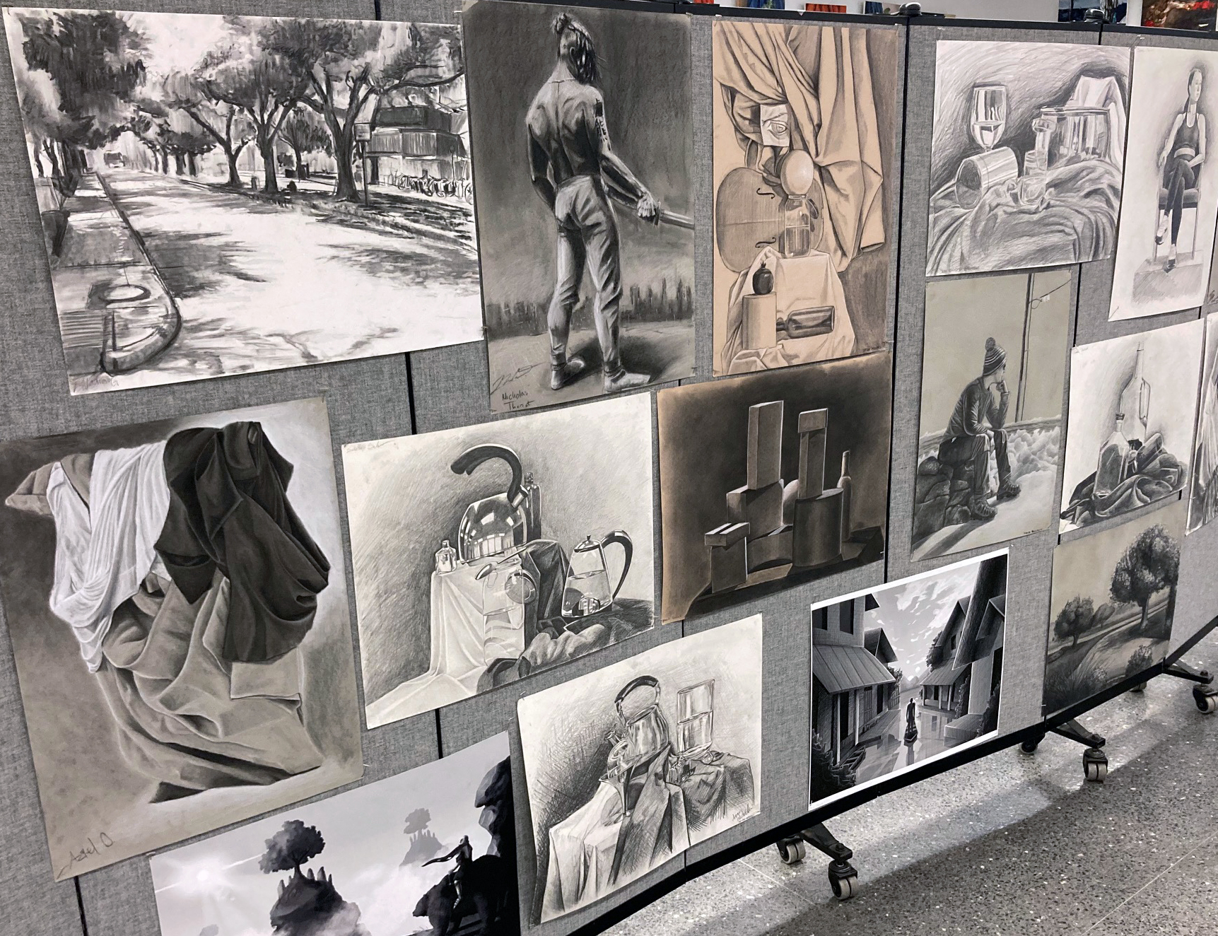 A series of drawings on display.