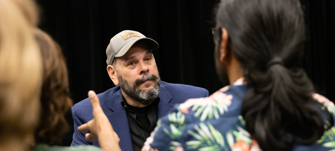 Joel McCrary, a veteran actor and improv comedian, listening to students
