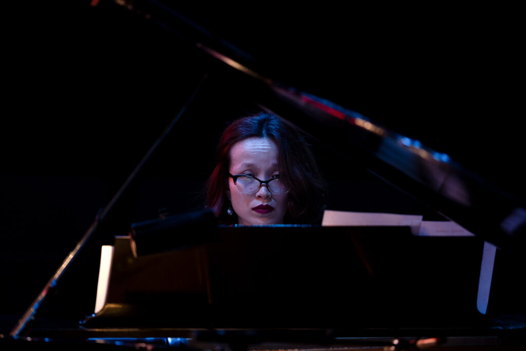 An artist plays a piano