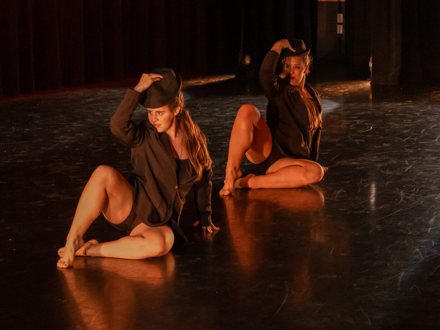Two women on the floor during a dance performance