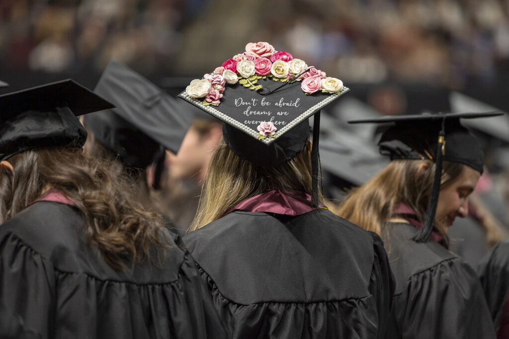 Back of a graduate's hat that says don't worry your dreams are everywhere