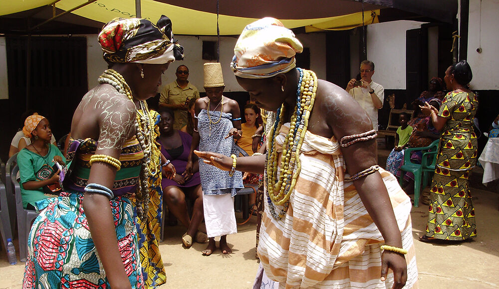 An image of two young women dressed with clusters of beads as part of the Dipo puberty rite ceremony among the Krobo-Odumase people in the Eastern region of Ghana.