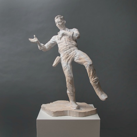 A sculpture of a male character in Western attire.
