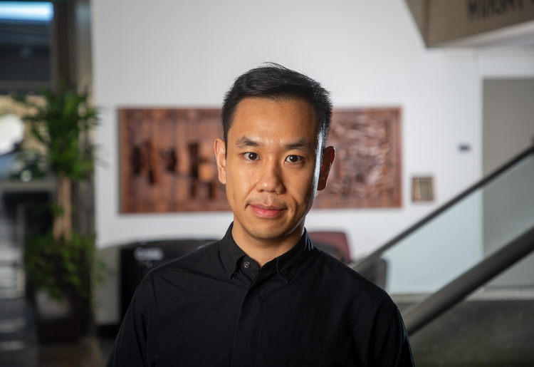 A university professor smiles for a portrait photo.