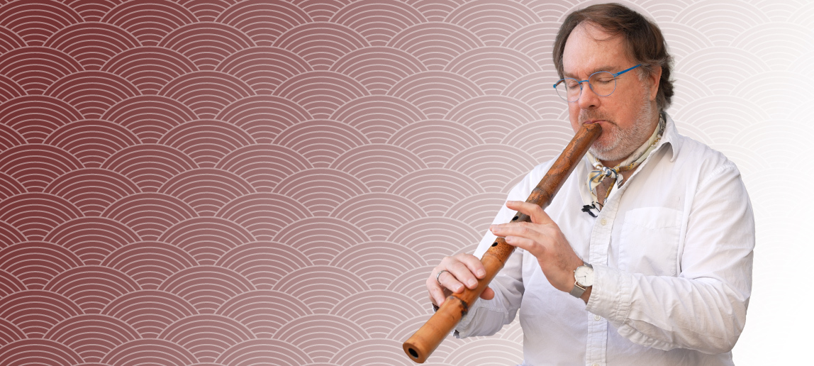 A music professor plays a shakuhachi, an end-blown bamboo flute.