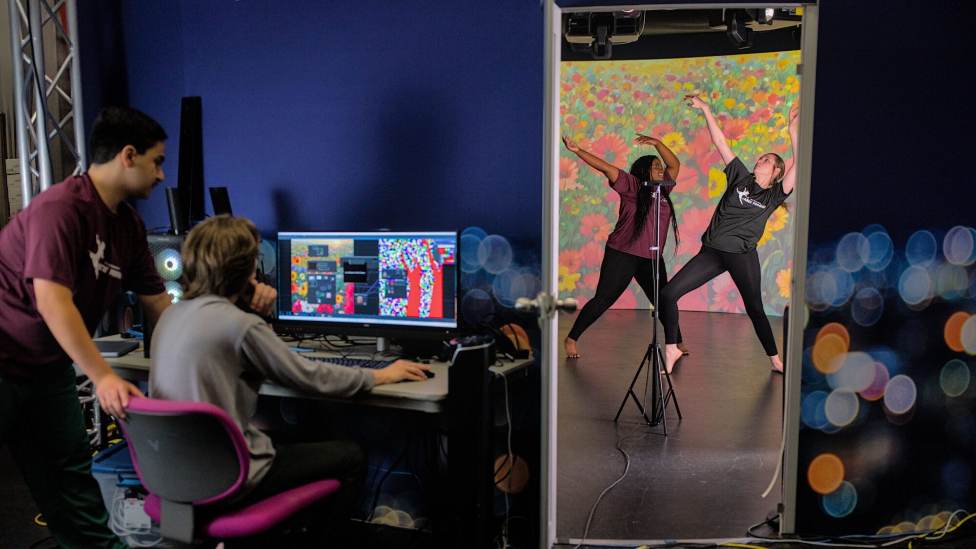 The dance moves of two students are captured by a video camera and processed by AI to generate responsive art in real-time.