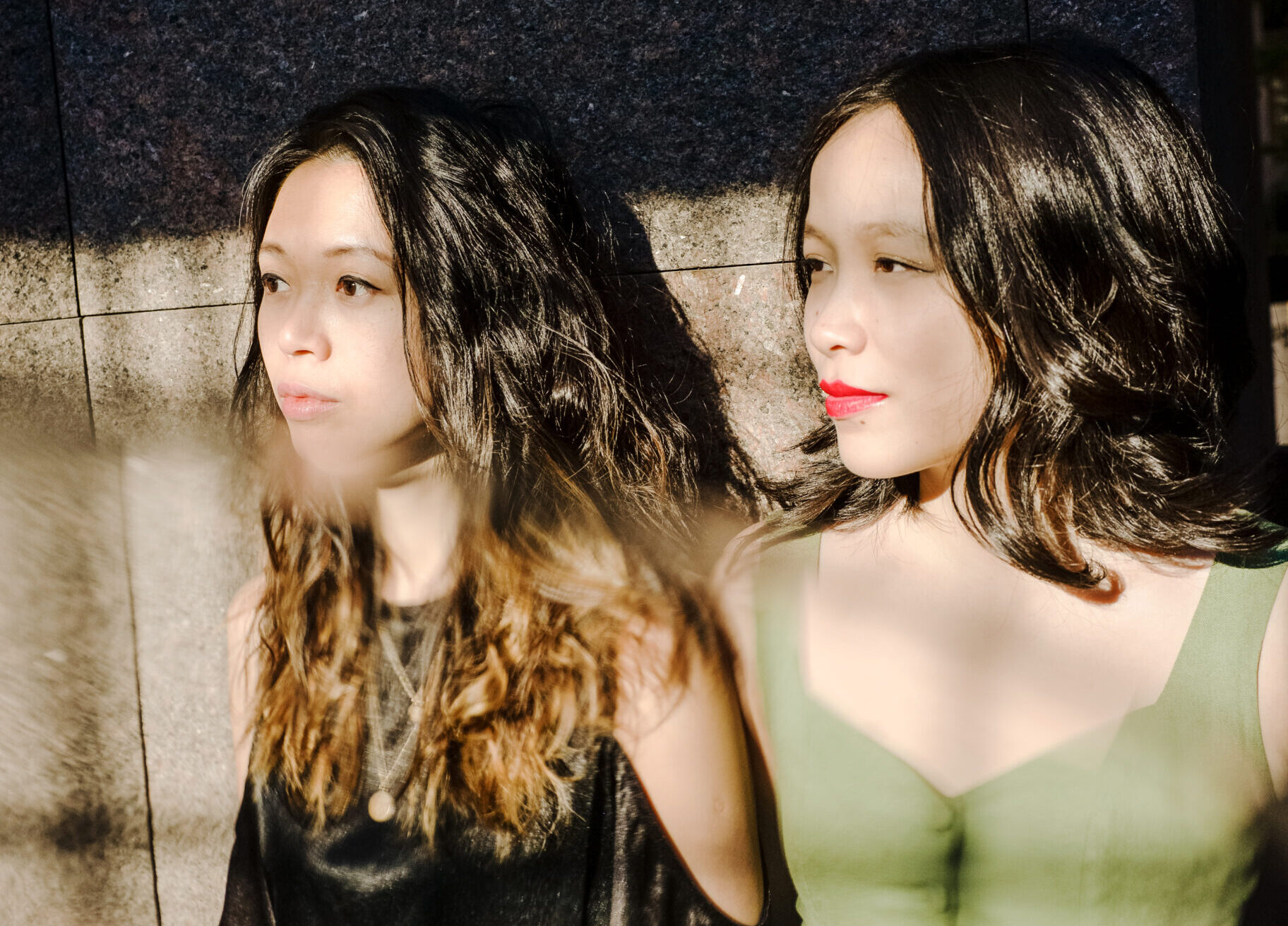 Two performers standing in front of a wall