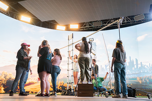A crew of college students work on a short film on a virtual production stage.