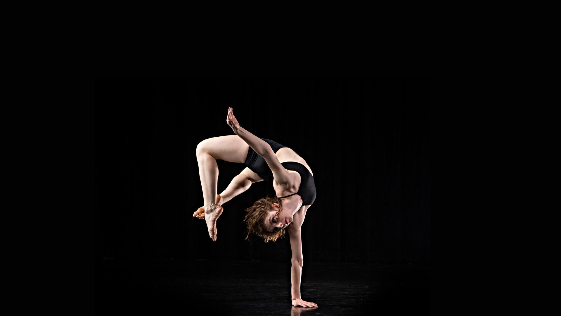 Dance flips backwards in front of black background