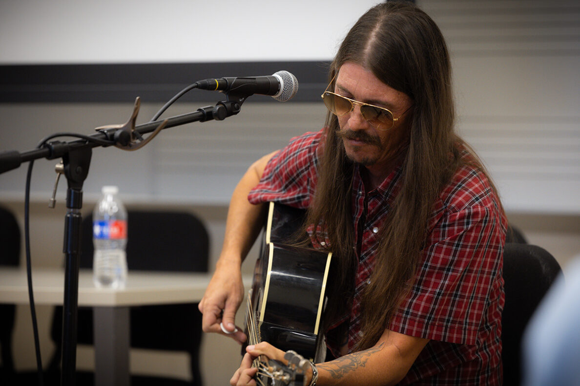 Singer-songwriter plays guitar