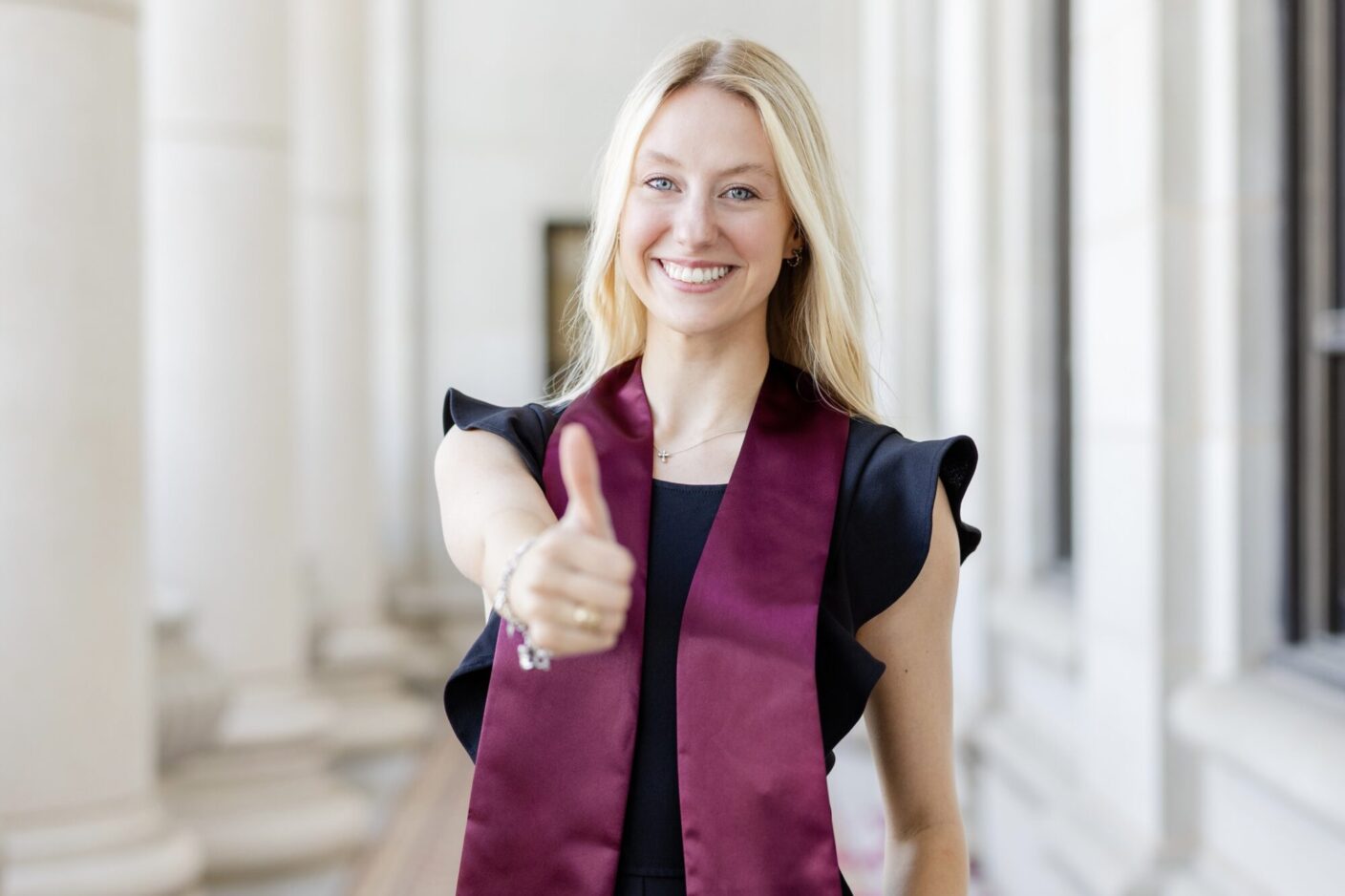 A university student poses for a graduation headshot photo.